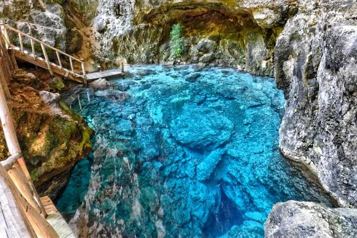 Aerial view of the Hoyo Azul cenote below a cliff