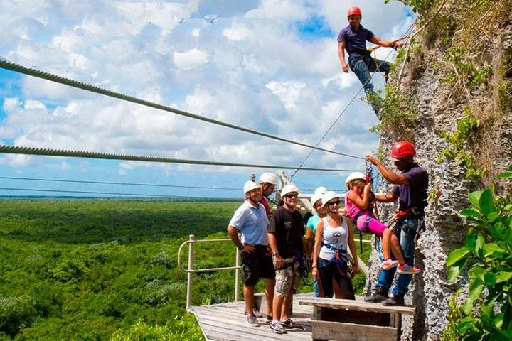 Guests on a zipline platform above the jungle