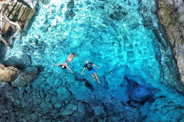 Swimmers in the Hoyo Azul cenote