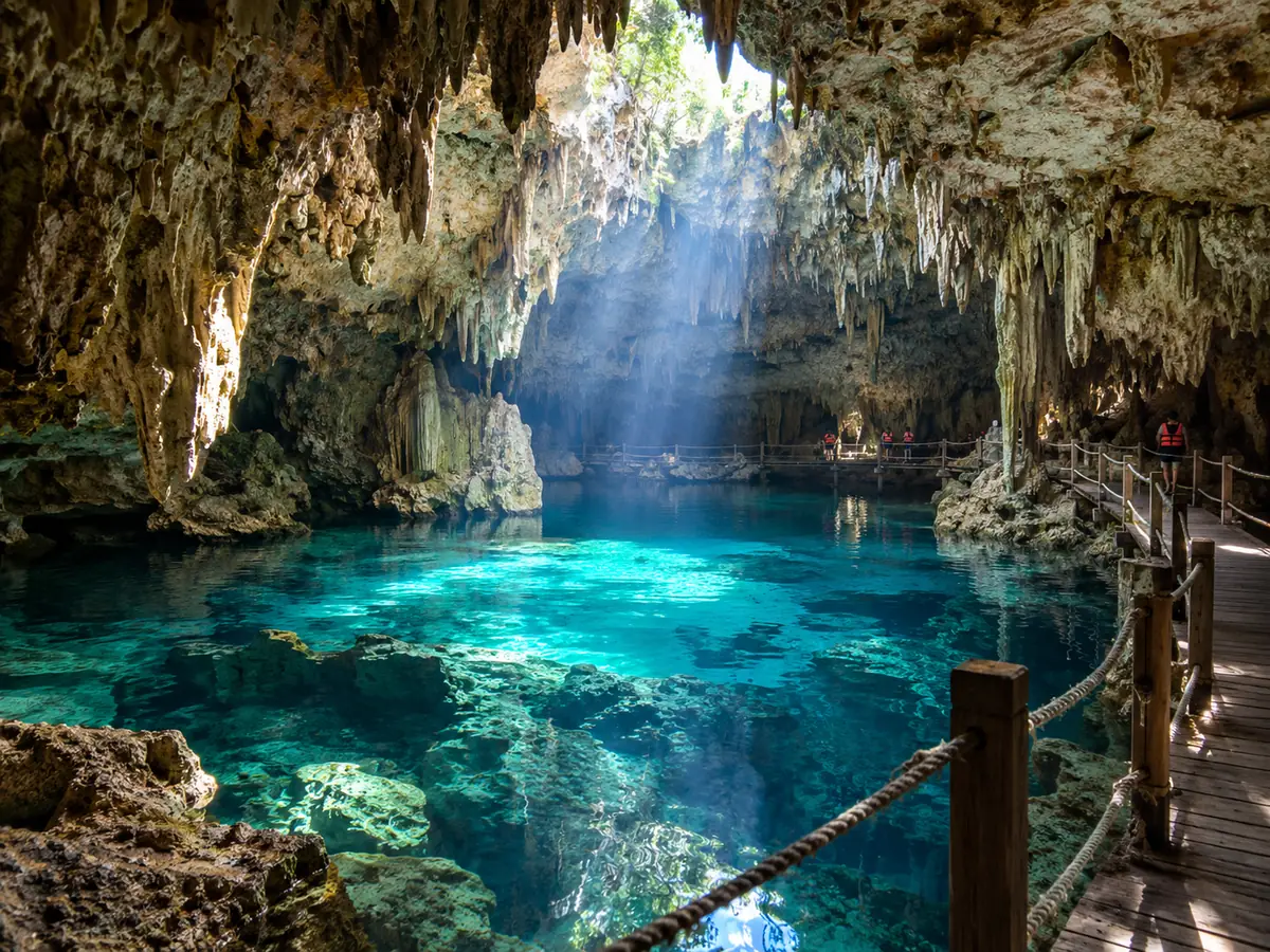 A turquoise pool inside a limestone cave